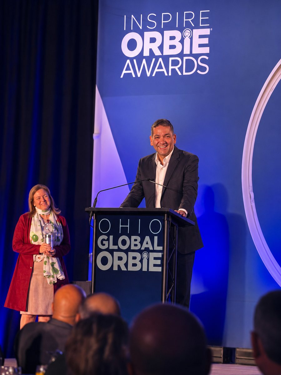 Srini Koushik at the podium of the Ohio Global ORBIE Awards